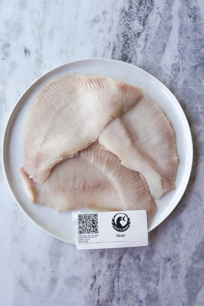 raw skate on white plate